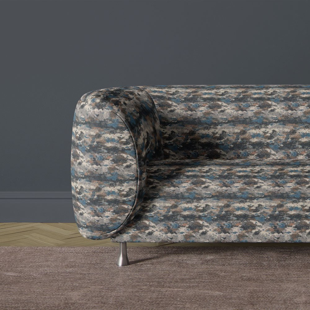 Texture No.9 blue upholstery fabric on sofa featuring organic mottled design in deep blue and earthy tones with printed texture finish