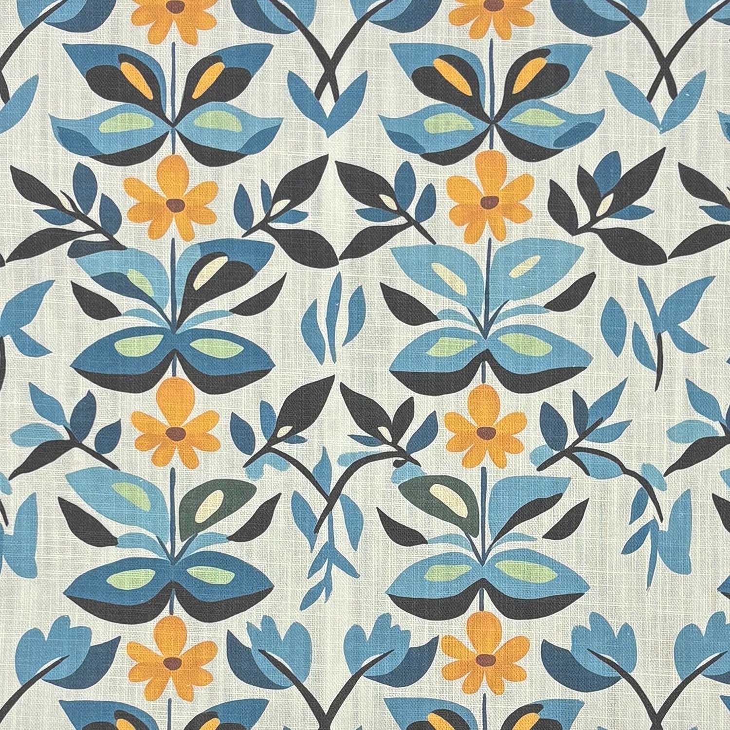 Flat lay of Tulpan No.1 blue and ochre floral upholstery fabric on linen blend