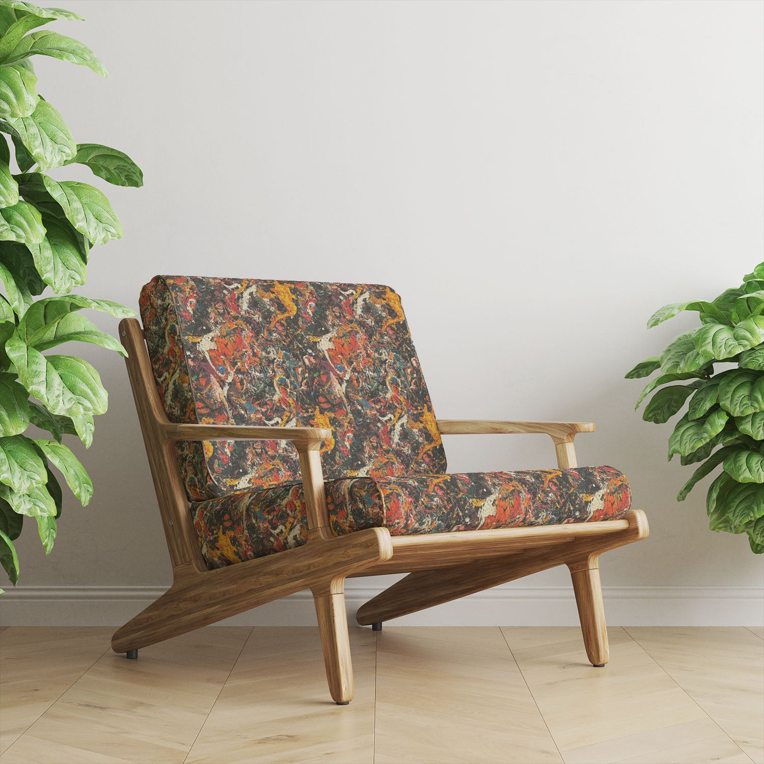 Statement upholstery fabric armchair featuring bold multicoloured abstract splatter design on a dark base in a modern interior setting